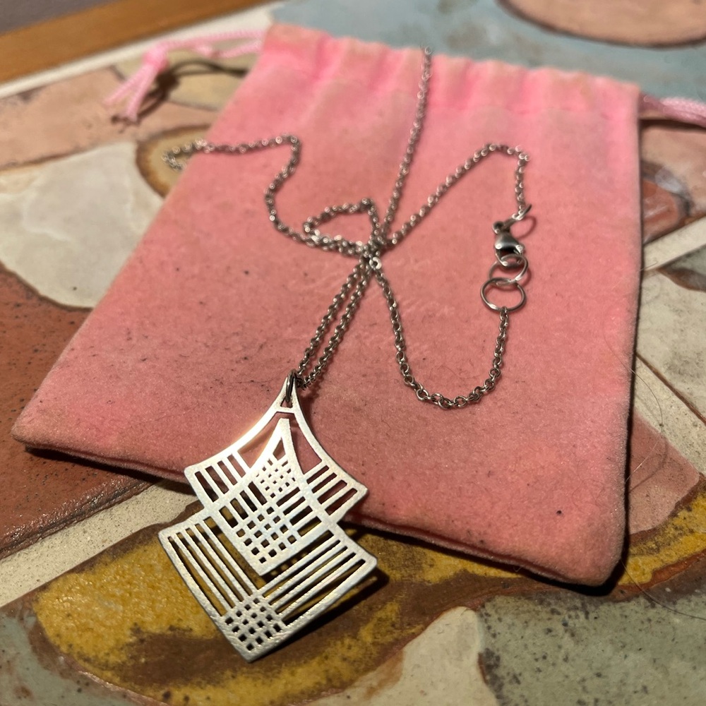 Jane Hollinger silver necklace with laser cut pendant.